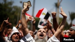 A protester, who supports former Egyptian President Mohamed Mursi, chants slogans during a rally near Cairo University after Friday prayers in Cairo July 5, 2013. Islamist allies of ousted president Mursi called on people to protest on Friday to express o