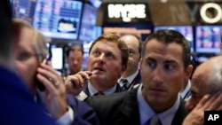 Traders gather at a post on the floor of the New York Stock Exchange, Aug. 27, 2013.