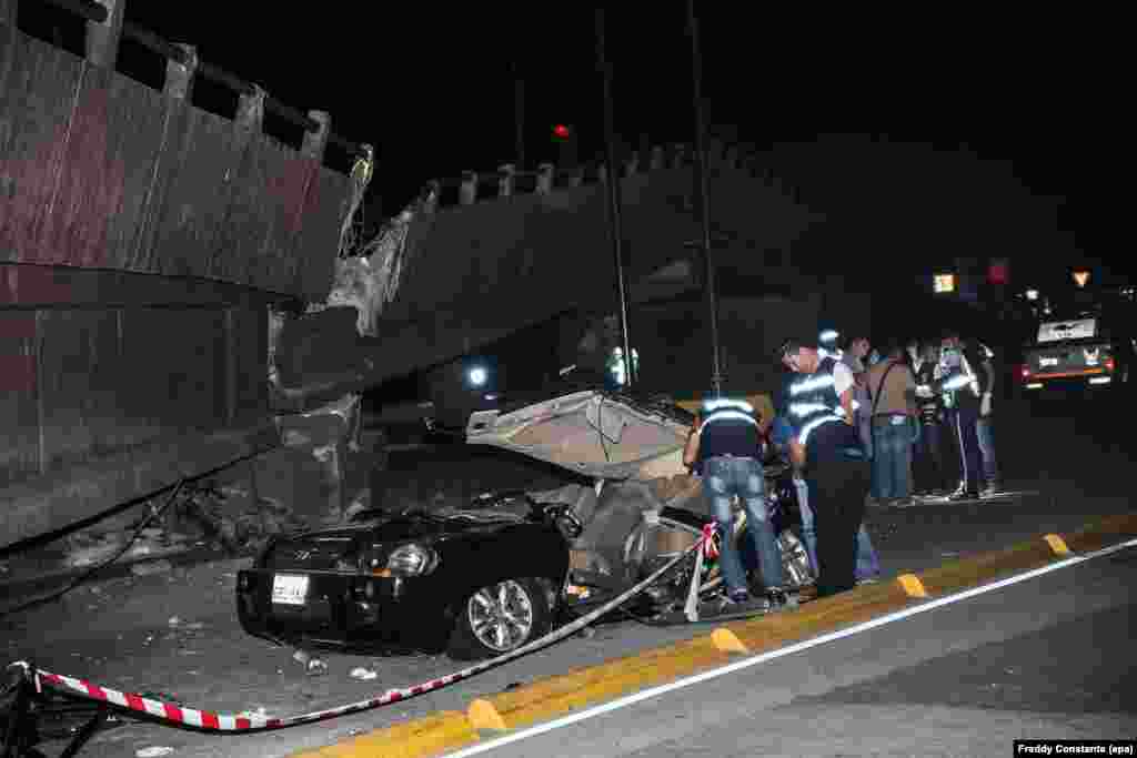 Members of Ecuadoran emergency services check a car after a bridge collapsed due to a 7.8 magnitude earthquake, in the city of Guayaquil, April 16, 2016.