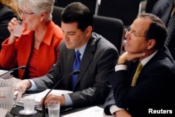 FILE - Dr. Scott Gottlieb, center, appeared as an American Enterprise Institute resident fellow when he participated in a hearing on health care reform before the Senate Health, Education, Labor and Pensions Committee on Capitol Hill in Washington, June 1