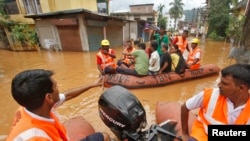 India's National Disaster Response Force (NDRF) personnel use rafts to rescue flood-affected residents after heavy rains at Guwahati in the northeastern Indian state of Assam, June 27, 2014. 