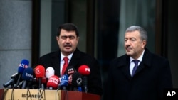 Istanbul Gov. Vasip Sahin, left, accompanied by Police Chief Mustafa Caliskan, talks to the media during a news conference regarding the arrest of a suspect of New Year's nightclub attack in Istanbul, Jan. 17, 2017.