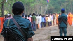 In this file photo, Cambodian armed police monitor last year's tree blessing ceremony in Prey Lang protected forest. (Courtesy photo of Licadho)