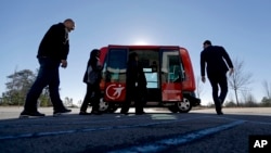 FILE - A driverless shuttle sits on display at the Riverside EpiCenter in Austell, Georgia, Jan. 26, 2017. 