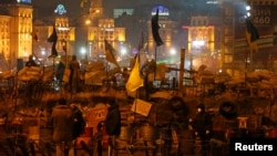Demonstrators gather at a barricade near Independence Square where pro-European integration protesters are holding a rally in central Kyiv, Ukraine, Dec. 13, 2013.