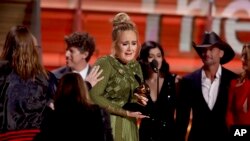 Adele accepts the award for album of the year for "25" at the 59th annual Grammy Awards, Feb. 12, 2017.