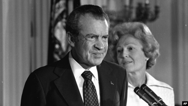 FILE - President Richard M. Nixon and his wife, Pat Nixon, stand together in the East Room of the White House in Washington, Aug. 9, 1974.