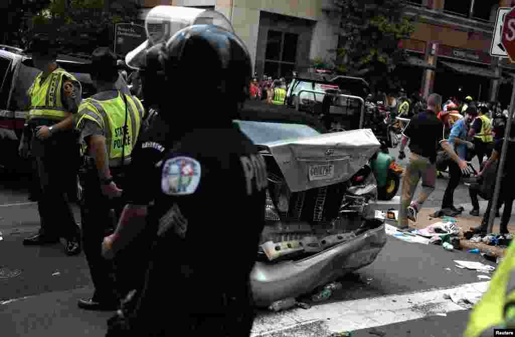 First responders stand by a car that drove through a group of counter protesters at the &quot;Unite the Right&quot; rally Charlottesville, Aug. 12, 2017.