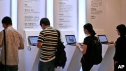 Visitors browse the Internet on laptop computers.