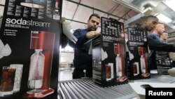 Employees pack boxes of SodaStream appliances at its factory in the West Bank Jewish settlement of Maale Adumim Jan. 28, 2014. 