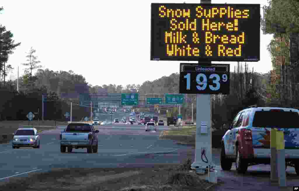A convenience store in Raleigh, North Carolina, advertises the &quot;essentials&quot; as a winter storm threatens to dump the first big snow of the season, Jan. 21, 2016.
