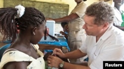 FILE - A staff member of the Global Alliance for Vaccines and Immunization inoculates a child with a rotavirus vaccine at in the village of Nkyenoa, Ghana, April 27, 2012. The WHO said up to 200,000 children globally die of the diarrheal disease each year. 