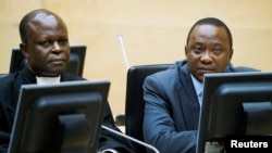 FILE - Kenya's President Uhuru Kenyatta (R) and a member of the Defense Council attend a hearing at the International Criminal Court in The Hague, Netherlands, Sept. 21, 2011.