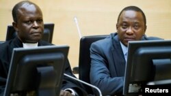 FILE - Kenya's President Uhuru Kenyatta (R) and a member of the Defense Council attend a hearing at the International Criminal Court in The Hague, Netherlands, Sept. 21, 2011.