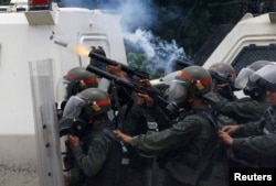 Riot police fire tear gas while clashing with opposition supporters rallying against President Nicolas Maduro in Caracas, Venezuela, May 3, 2017.