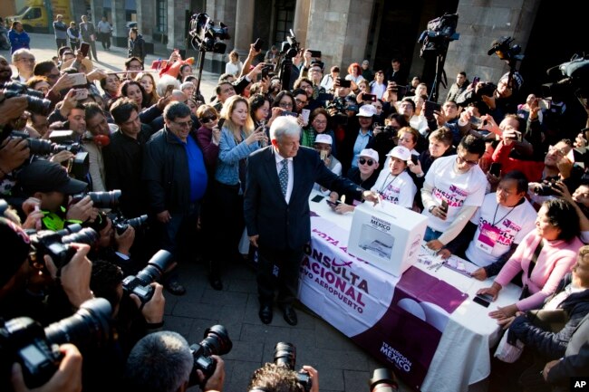 Mexico's President-elect Andres Manuel Lopez Obrador casts his vote on whether to continue with the $13 billion airport to replace the current Benito Juarez International Airport in Mexico City, Oct. 24, 2018.