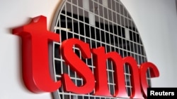 FILE - The logo of Taiwan Semiconductor Manufacturing Co (TSMC) is pictured at its headquarters, in Hsinchu, Taiwan, Jan. 19, 2021. 