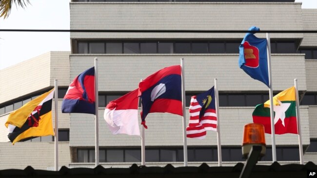 FILE - Flags of member countries fly at the ASEAN Secretariat in Jakarta, Indonesia, April 22, 2021. Southeast Asia's top diplomats will discuss in an emergency meeting today whether to allow Myanmar's military leader to attend an annual summit.