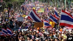 Thai anti-government protesters march in a street, in Bangkok, Thailand, Dec. 22, 2013.