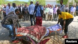 FILE - Members of the parliament, relatives carry the body of legislator Mohamed Mohamud Hayd who was shot dead in Mogadishu.