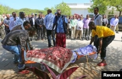 Members of parliament and relatives carry the body of slain legislator Mohamed Mohamud Hayd who was shot dead in the Hamarweyne district of Mogadishu, July 3, 2014.