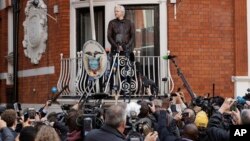 FILE - WikiLeaks founder Julian Assange stands on the balcony of the Ecuadorian embassy, prior to speaking, in London, May 19, 2017.