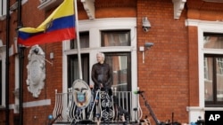FILE - WikiLeaks founder Julian Assange stands on the balcony of the Ecuadorian embassy prior to speaking, in London, May 19, 2017.