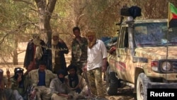 FILE - Tuareg separatist rebels rest in the shade of a tree near Tabankort, Mali, Feb. 13, 2015. 