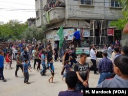 In a pick-up truck decorated with Hamas flags in Gaza, a man preached into the microphone outside a funeral for Nasser Abdullah, who was killed in recent protests.