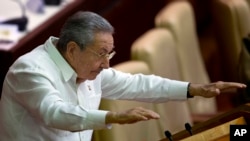 FILE - Cuban President Raul Castro gestures to lawmakers during the closing of the legislative session at the National Assembly in Havana.