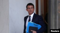 FILE - French Prime Minister Manuel Valls leaves the Elysee Palace in Paris, November 9, 2016. Before being able to compete in the presidential election, Valls will face off with other candidates in the Socialist party primary in January.