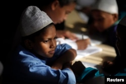 FILE - A madrasa student reads the Qur'an.