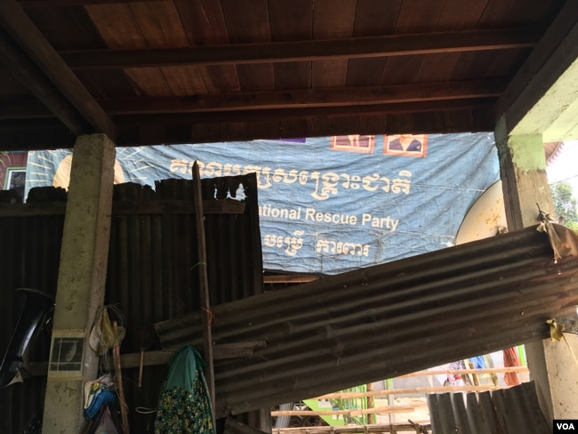 After the opposition party was dissolved, Keo Eat was ordered by police to take down from his home all the banners bearing its logo. He complied but turned one inward as a gesture of defiance, Nov. 27, 2017.