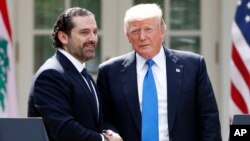 President Donald Trump, right, shakes hands during a joint news conference with Lebanese Prime Minister Saad Hariri in the Rose Garden of the White House, July 25, 2017, in Washington. 