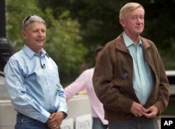 FILE - Former New Mexico Gov. Gary Johnson, left, stands with his vice presidential running mate, former Massachusetts Gov. William Weld, during a campaign rally, Aug. 25, 2016, in Concord, N.H.