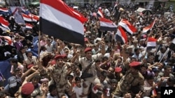 Yemeni army soldiers lifted by anti-government protestors, chants slogans and wave their national flag as they celebrate President Ali Abdullah Saleh's departure to Saudi Arabia, in Sanaa, Yemen, Sunday, June 5, 2011