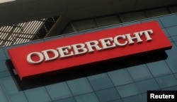 FILE - A sign of the Odebrecht Brazilian construction conglomerate is seen at their headquarters in Lima, Peru, Jan. 5, 2017.