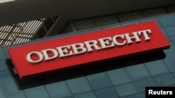 FILE - A sign of the Odebrecht Brazilian construction conglomerate is seen at its headquarters in Lima, Peru, Jan. 5, 2017. 