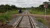 A man rides a bike over a railway line in Moatize in Tete province February 13, 2013. The Renamo opposition party is threatening to paralyze the Mozambique railway that transports coal to the coast for export.