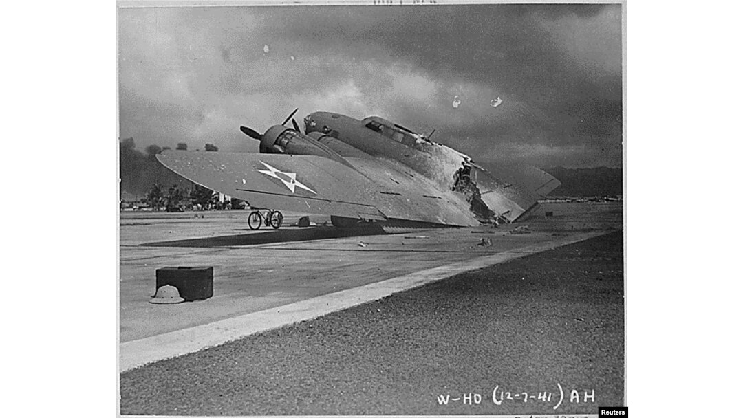 FILE - A burnt B-17C aircraft rests near Hangar Number Five, Hickam Field, following the attack by Japanese aircraft on Pearl Harbor, Hawaii Dec. 7, 1941.