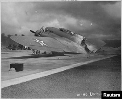 FILE - A burnt B-17C aircraft rests near Hangar Number Five, Hickam Field, following the attack by Japanese aircraft on Pearl Harbor, Hawaii Dec. 7, 1941.
