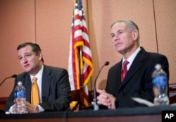 Republican presidential candidate Sen. Ted Cruz, R-Texas, left, and Texas Gov. Greg Abbott, right, speak about the resettlement of Syrian refugees in the U.S., during their joint news conference on Capitol Hill in Washington, Dec. 8, 2015.