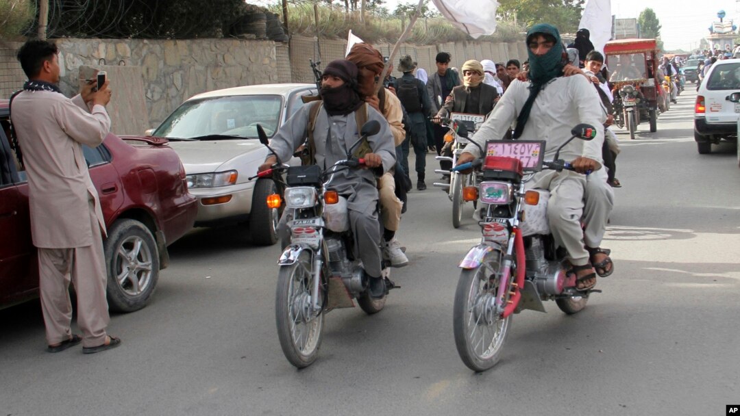 FILE - Taliban fighters ride their motorbikes inside Ghazni city, west of Kabul, Afghanistan, June 16, 2018.