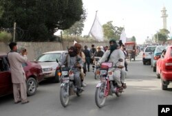 FILE - Taliban fighters ride their motorbikes inside Ghazni city, west of Kabul, Afghanistan, June 16, 2018.