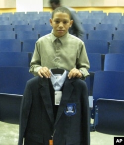 Jamarcus Preston, who will be entering 6th grade at Obama Academy, shows off his new school uniform.