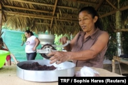 Basilia Jackson Jackson grinds cacao beans at the Siwakabata agro-ecology farm, Talamanca, Costa Rica, May 10, 2018.