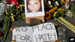 A makeshift memorial of flowers and a photo of victim, Heather Heyer, sits in Charlottesville, Va., Aug. 13, 2017. Heyer died when a car rammed into a group of people who were protesting the presence of white supremacists who had gathered in the city for a rally. 