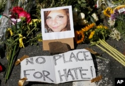 A makeshift memorial of flowers and a photo of victim, Heather Heyer, sits in Charlottesville, Va., Aug. 13, 2017.