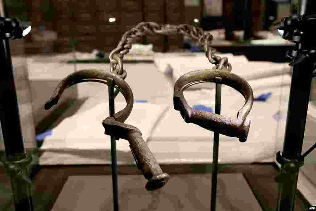 A pair of slave shackles are on display in the Slavery and Freedom Gallery in the Smithsonian's National Museum of African American History and Culture during the press preview on the National Mall on Sept. 14, 2016 in Washington.
