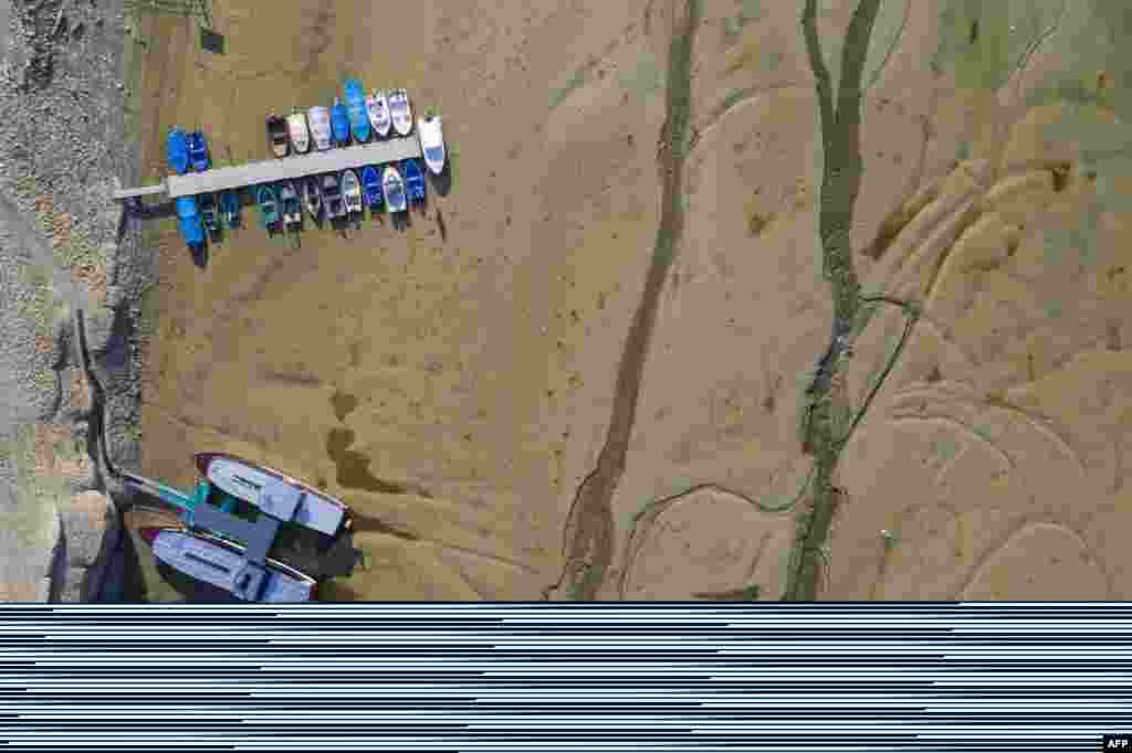 This aerial view shows boats sitting on the bed of the dried-out Doubs river in Villers-le-Lac, eastern France.